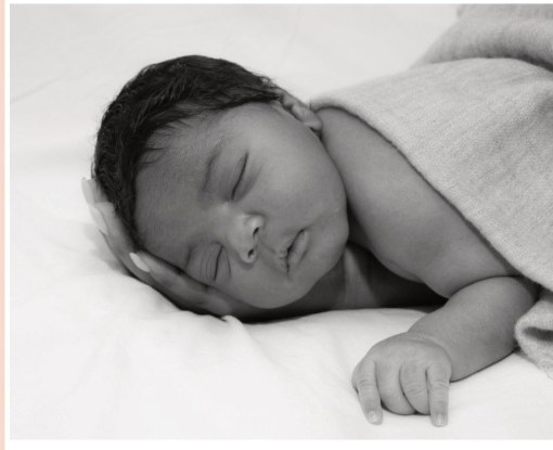 Sleeping newborn wrapped in a soft blanket